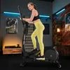 A woman is exercising on a TREX SPORT Crosstrainer in a home gym setting. Produktbild-Vorschau