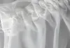 A close-up view of the top edge of a white sheer curtain, showing the gathering tape and loops for hanging. Produktbild-Vorschau