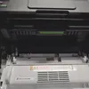 Close-up view of the interior of a Brother printer, showing the toner cartridge area and some internal components. Produktbild-Vorschau