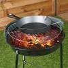 A cast iron skillet is placed on a grill over hot coals. Produktbild-Vorschau