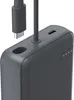 Close-up of a dark gray power bank with a USB-C cable being inserted into one of its ports. Four small white dots indicating battery level are visible on the side. Anteprima dell’immagine prodotto
