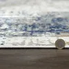 A close-up, low-angle shot of a rug with a coin for scale. Produktbild-Vorschau