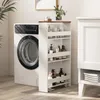 A slim rolling shelf unit filled with bottles and containers is placed next to a washing machine. Produktbild-Vorschau