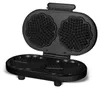 An open black waffle maker with heart-shaped molds. Podgląd zdjęcia produktu