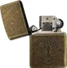 A close-up shot of an open antique brass lighter with a tree of life design. Náhľad obrázku produktu