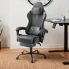 A gray and green gaming chair with a footrest is shown in a room with a desk and a plant. Voir les images du produit