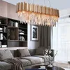 A modern living room with a large sectional sofa, bookshelves, and a long, rectangular crystal chandelier. Produktbild-Vorschau