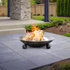 A fire pit with burning logs sits on a patio in a backyard setting. Anteprima dell’immagine prodotto