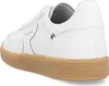 A close-up side view of a white sneaker with a tan sole. Produktbild-Vorschau
