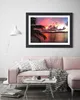 A living room scene with a pink sofa, coffee table, and a framed picture on the wall. Produktbild-Vorschau