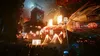 A vibrant, futuristic city scene at night, possibly during a festival, with many people in the foreground looking towards a large, illuminated display or performance. Produktbild-Vorschau