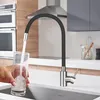 A person is filling a glass with water from a modern kitchen faucet in a kitchen setting. Produktbild-Vorschau