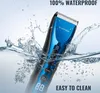 A blue and black hair trimmer is submerged in water with splashes, highlighting its waterproof feature. Produktbild-Vorschau