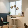 A dining area with a table, chairs, and pendant lights. Produktbild-Vorschau