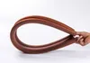 A hand is holding a bent brown foam seal for doors and windows. Náhled obrázku produktu