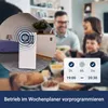 A family is eating dinner while a mobile air conditioner is shown in a bedroom setting with sound waves emanating from it, suggesting its operation. Produktbild-Vorschau