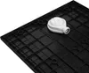 The underside of a black shower tray with a white drain assembly attached. Produktbild-Vorschau