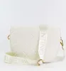 A white quilted handbag with a white strap with the Valentino logo printed on it, shown against a white background. Anteprima dell’immagine prodotto