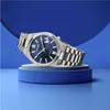 A silver Citizen watch with a blue face is displayed on a blue pedestal against a blue background. Podgląd zdjęcia produktu