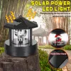 A solar-powered LED light shaped like a lighthouse, placed on a rock in a garden setting with bamboo and a pagoda in the background. Anteprima dell’immagine prodotto