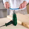 A person is using a heat gun to shrink a piece of heat shrink tubing around a cable, with a wooden surface and a drill in the foreground. Produktbild-Vorschau