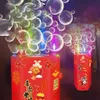 Rote Bubble-Maschine mit festlichen chinesischen Neujahrsdekorationen und bunten Blasen, die herausströmen, mit einer kleineren im Hintergrund Náhled obrázku produktu