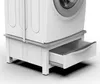A close-up view of a white washing machine stand with an open drawer. Podgląd zdjęcia produktu