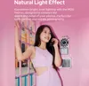 A woman is holding a pink retro phone next to a pink wall with a window. Podgląd zdjęcia produktu