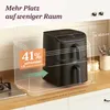 A black air fryer is shown on a kitchen countertop, with a transparent overlay highlighting its dimensions and space-saving features. Produktbild-Vorschau