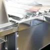 A close-up view of a stainless steel grease trap or filter grate. Produktbild-Vorschau