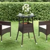 A patio set with a table and two chairs in a garden setting. Náhled obrázku produktu