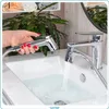 A hand holding a bidet shower head over a sink with water running from a faucet. Náhľad obrázku produktu