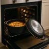 A casserole dish with food in it is placed inside an open oven. Náhled obrázku produktu