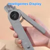 A hand holding a gray pet nail clipper with a digital display. Produktbild-Vorschau