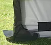 A close-up view of the bottom corner of a shelter or tent-like structure, showing its material and how it meets the ground. Produktbild-Vorschau