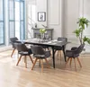 A dining room scene with a table and chairs set up for a meal. Produktbild-Vorschau