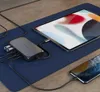 A Satechi USB-C hub is connected to a tablet and a smartphone, which are placed on a blue mat on a wooden desk. Voir les images du produit