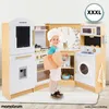 A child dressed as a chef stands in a toy kitchen, holding a cutting board. Podgląd zdjęcia produktu