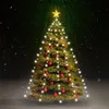 A decorated Christmas tree with lights and ornaments, set against a dark, snowy background with green light rays emanating from above. Produktbild-Vorschau
