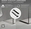 A shower drain with two different visible sides, one black and one silver, set against a grey tiled wall and white tiled floor. Náhľad obrázku produktu