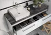 A bathroom vanity with a sink and storage drawers. Podgląd zdjęcia produktu