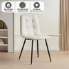 A beige upholstered chair with black metal legs is shown in a room with a white shelf on the left and a wooden paneled wall on the right. Above the chair, there are three circular icons with text. Produktbild-Vorschau