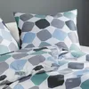 A close-up view of bedding with a geometric pattern. Produktbild-Vorschau