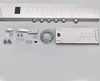 A shower panel system and its accessories laid out on a light gray surface. Náhled obrázku produktu