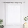 A white sheer curtain with a branch pattern hangs on a curtain rod in front of a window. A small plant and some candles are visible on a dresser to the right. Produktbild-Vorschau