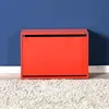 A red shoe cabinet against a blue wall and on a white rug. Voir les images du produit