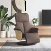 A brown faux leather recliner chair with wooden accents is placed in a modern living room setting, next to a large plant and a TV stand with a television. Produktbild-Vorschau