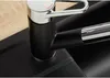 A close-up view of a modern kitchen faucet with a pull-out spray, set against a black sink and a wooden countertop. Produktbild-Vorschau