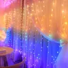 A room decorated with a curtain of LED lights in rainbow colors, with a small table and chair visible. Produktbild-Vorschau