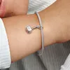 A close-up shot of a person's arm wearing a silver Pandora bracelet with a Thor's hammer charm. Podgląd zdjęcia produktu